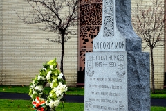 AOH-sponsored-the-An-Gorta-Mor-Great-Hunger-Memorial-and-fresh-floral-wreath-stand-among-tribute-bricks-honoring-local-Irish-